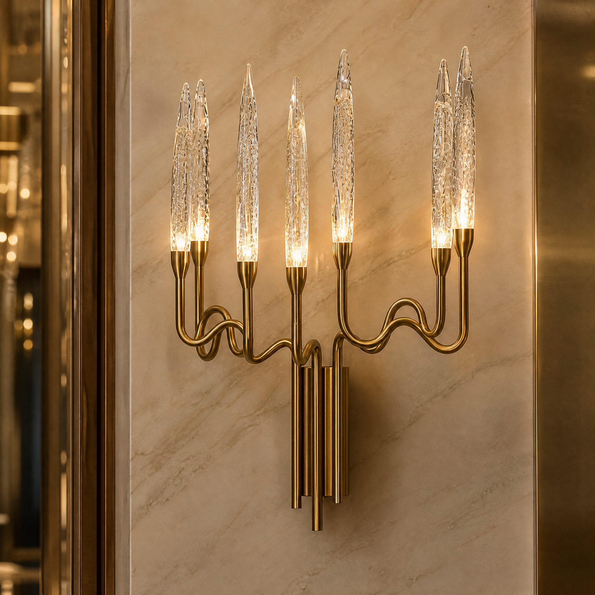 Macro closeup of the VORELLI Tiddington Wall Light, showcasing the detailed artistry of the large cone bubble-effect crystal and decorative sinuous metal frame.