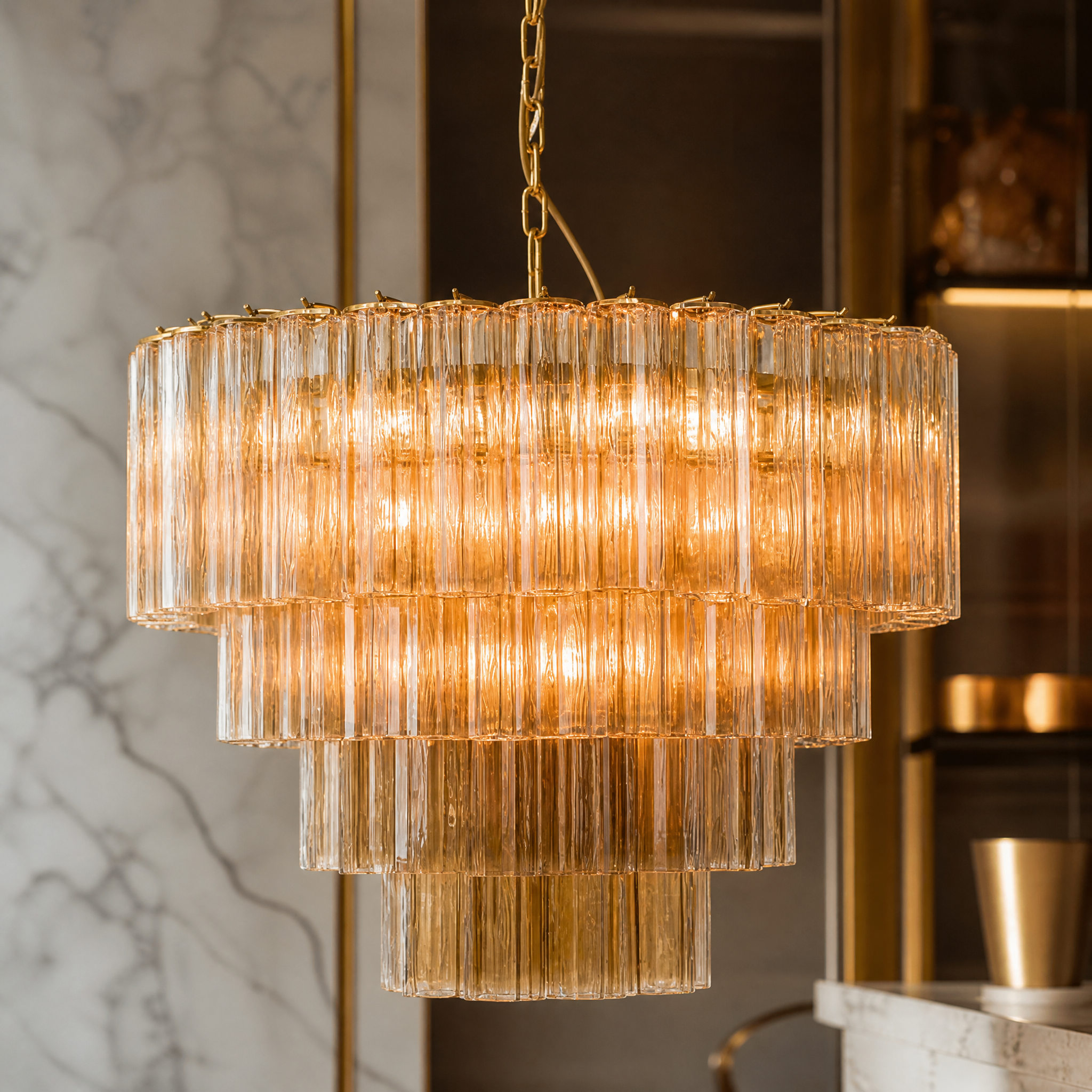 Macro shot of the fluted Murano glass tubes and satin brass frame on the VORELLI Trevisano large circular chandelier.