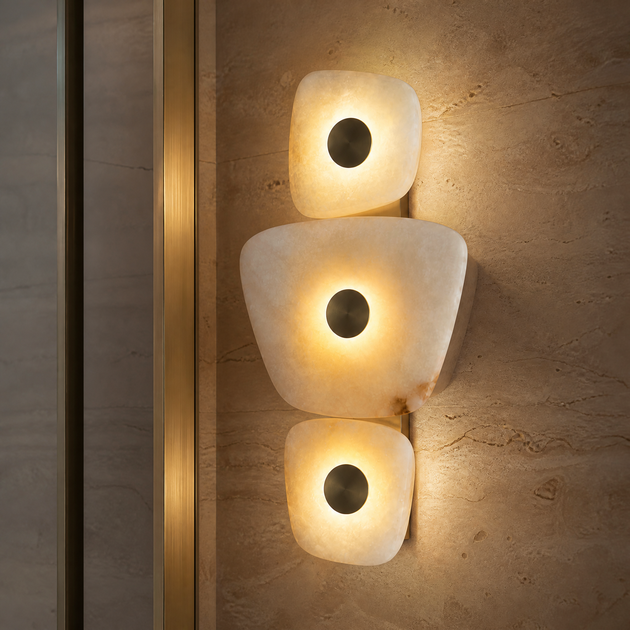 Close-up detail of the VORELLI Trivara wall light, highlighting the natural textures of the sculpted marble and its unique, asymmetrical form.