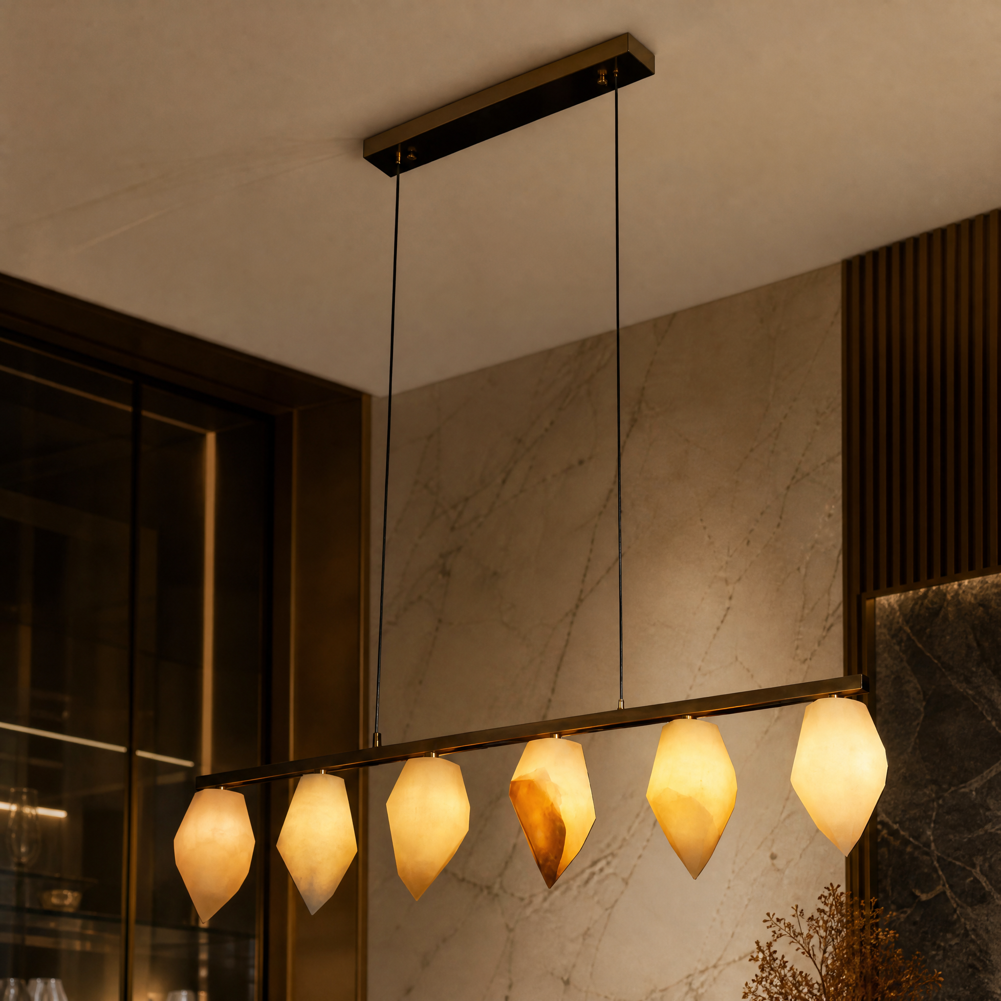 A macro close-up view of the natural textures and finely carved edges of the VORELLI Tuscana Marble Chandelier shade.