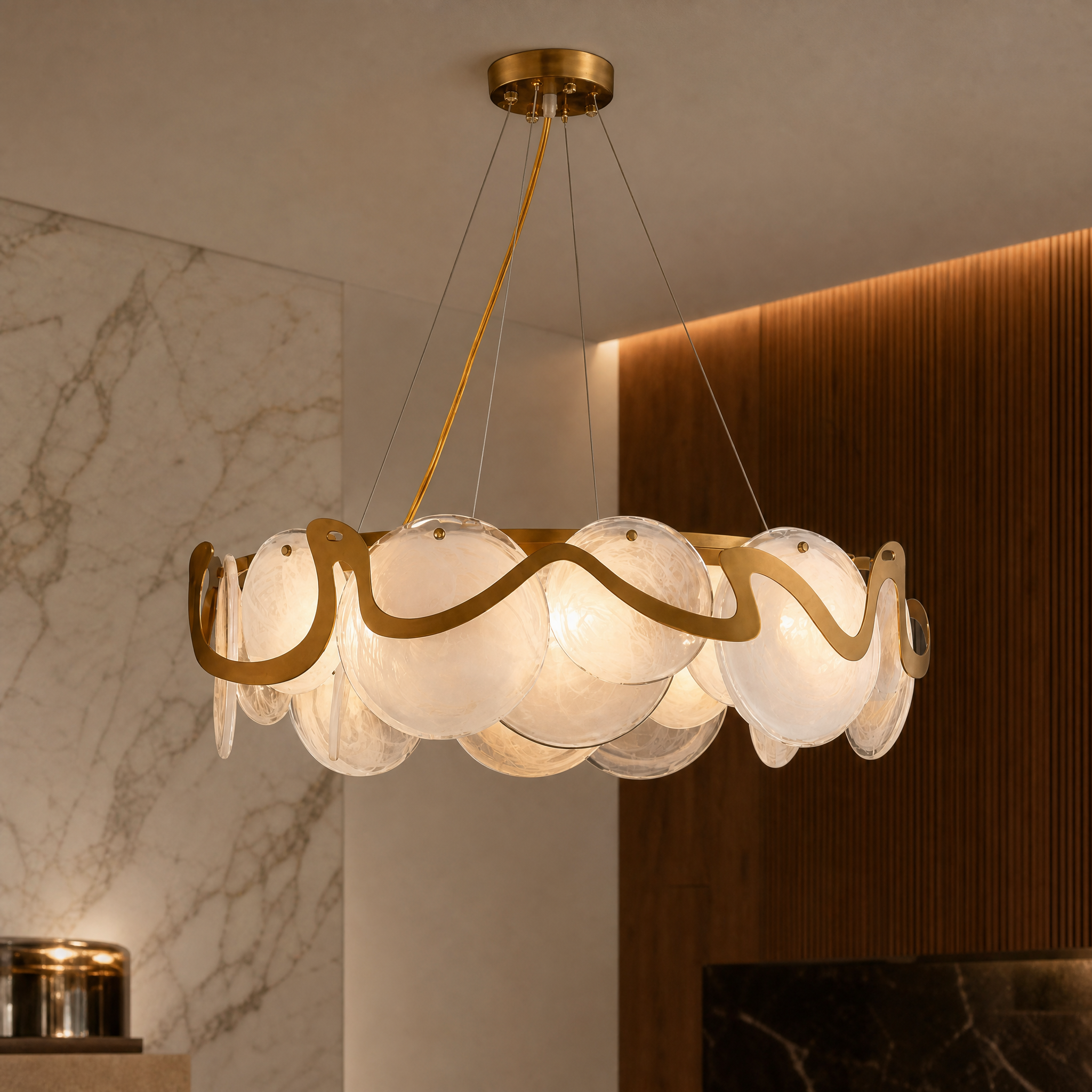 Detailed closeup of the intricate, coastal-wave-inspired hand-blown glass disks on the VORELLI Valparaíso Cristóbal circular chandelier.