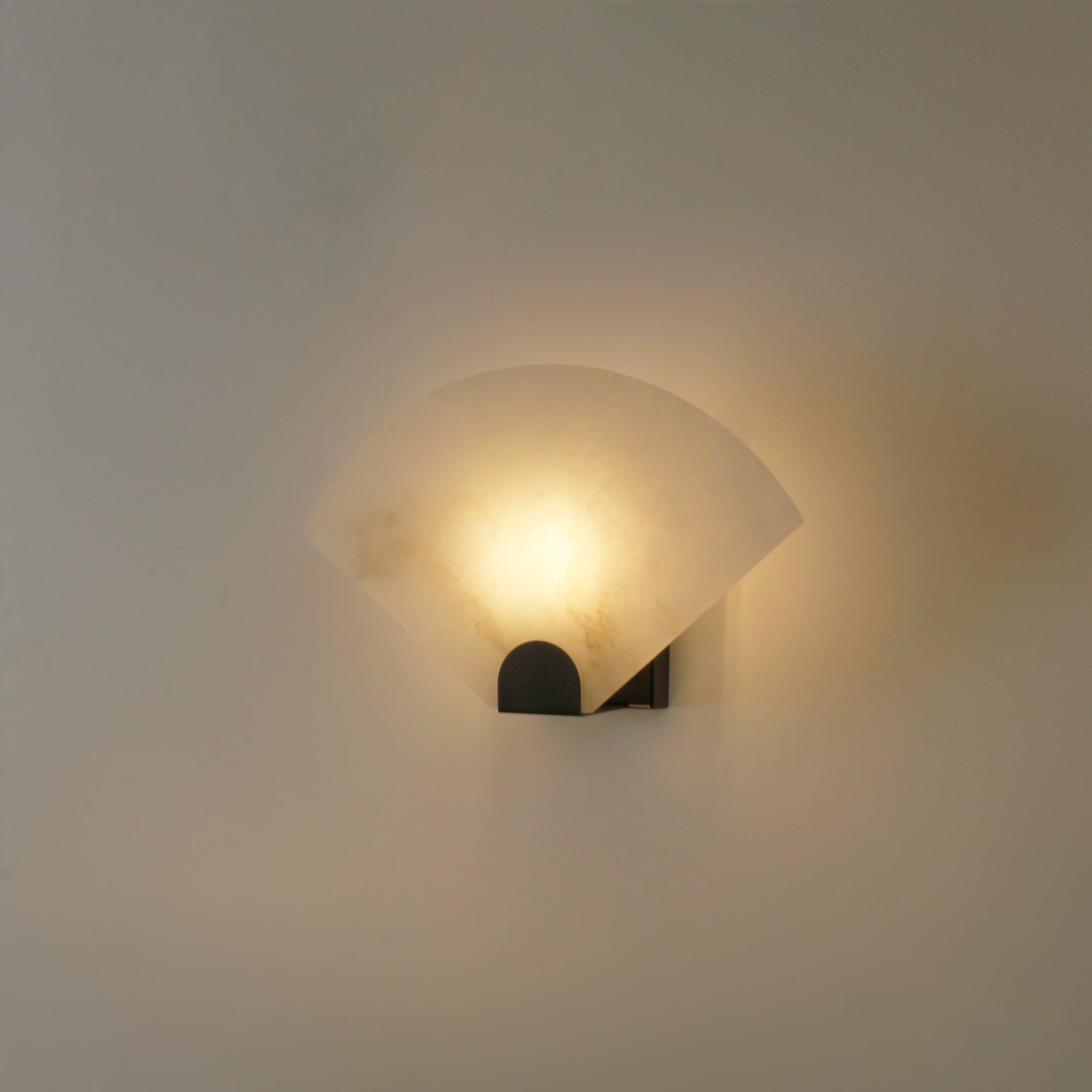 Marble wall light casting soft ambient glow on wall for luxury residential interior lighting
