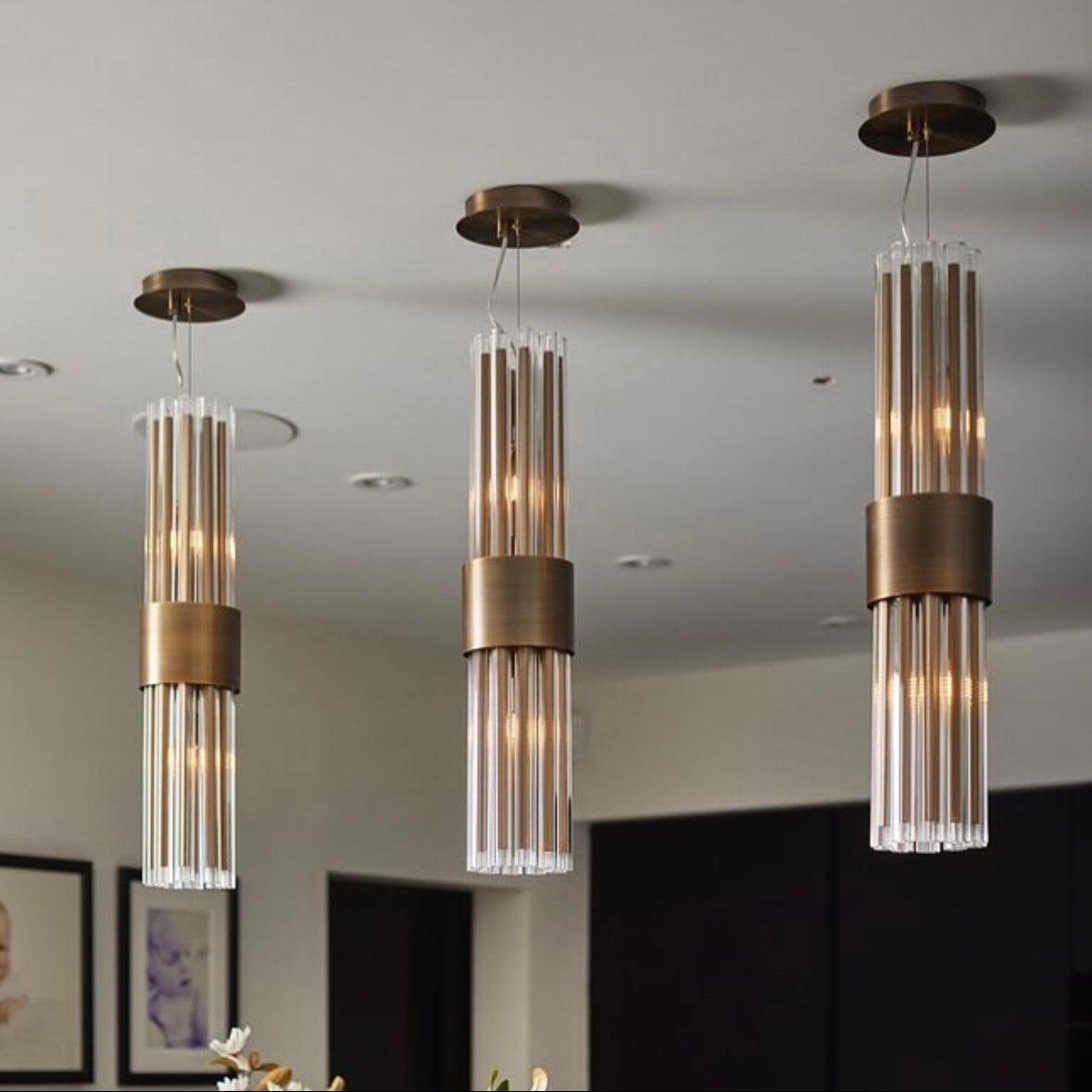Modern cluster of crystal pendant lights with vertical tubing for contemporary interior lighting