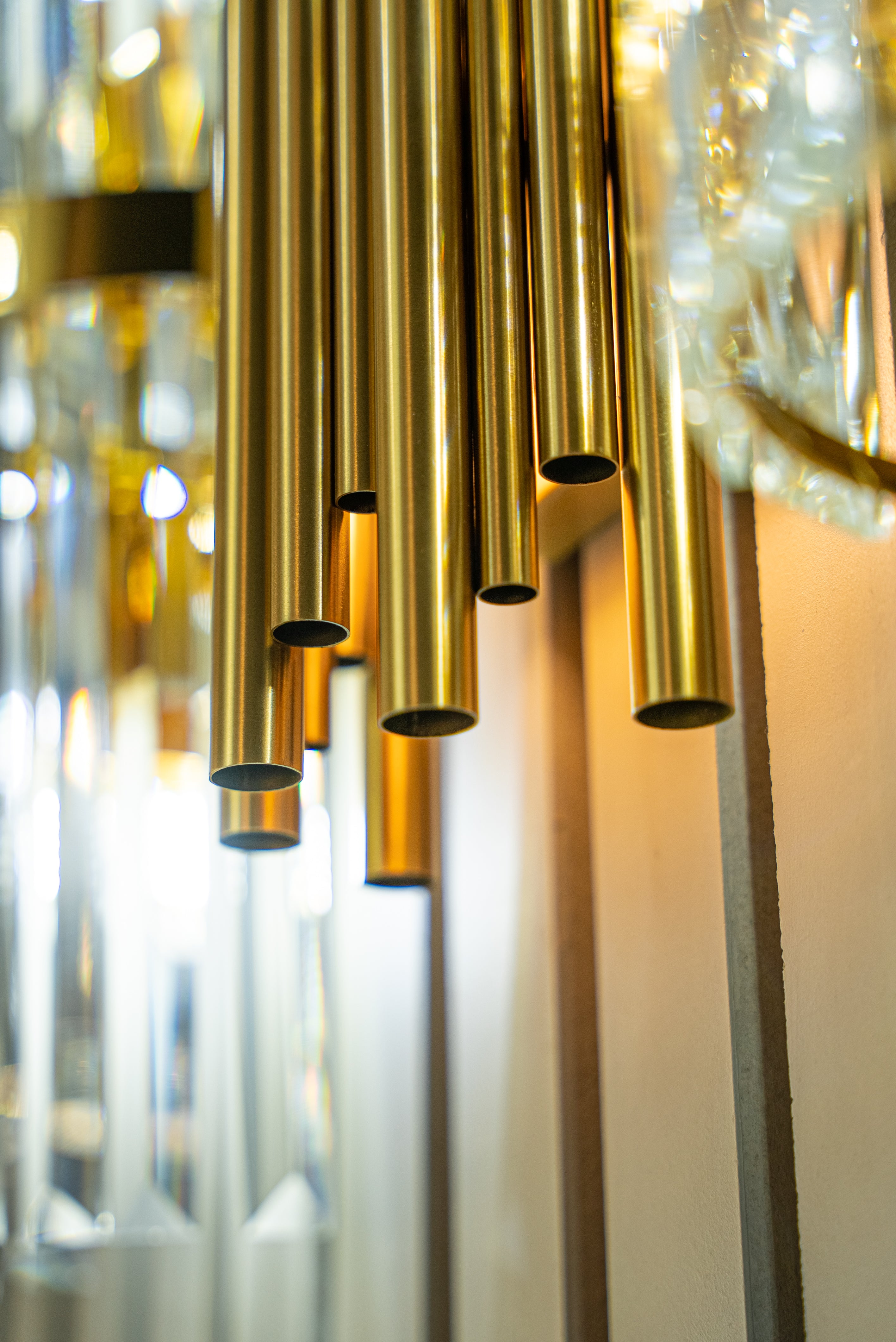 Modern wall lighting with vertical tubes enhancing open plan luxury interior space