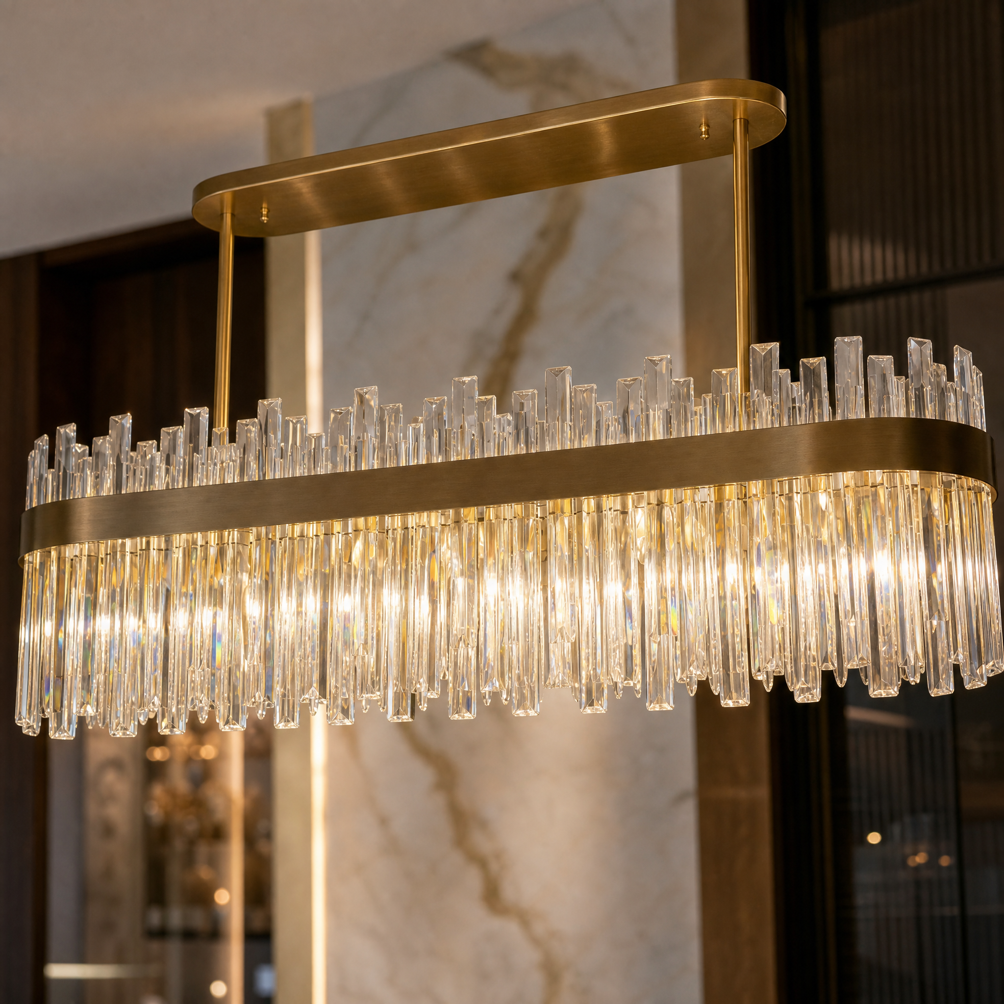 Close-up macro shot of the VORELLI Williston rectangular chandelier showing clear crystal bars set in a polished stainless steel frame.