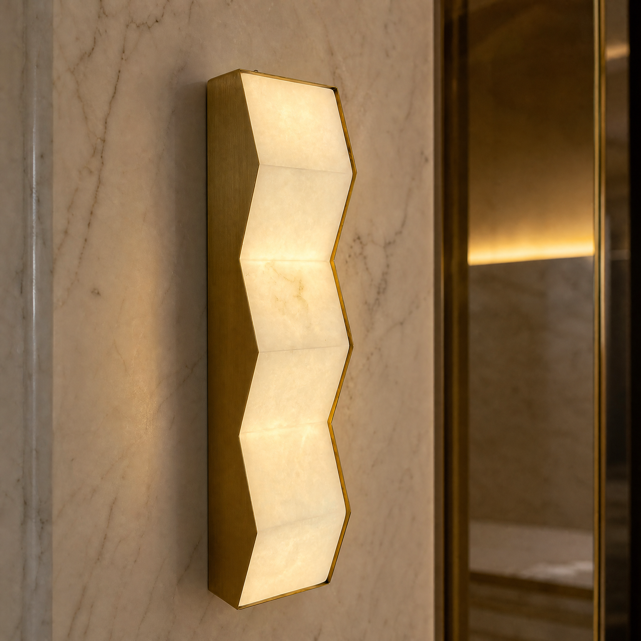 A detailed close-up of the Zigari wall light highlighting the clean lines of its zig-zag silhouette and the natural veining of the soft luminous marble.