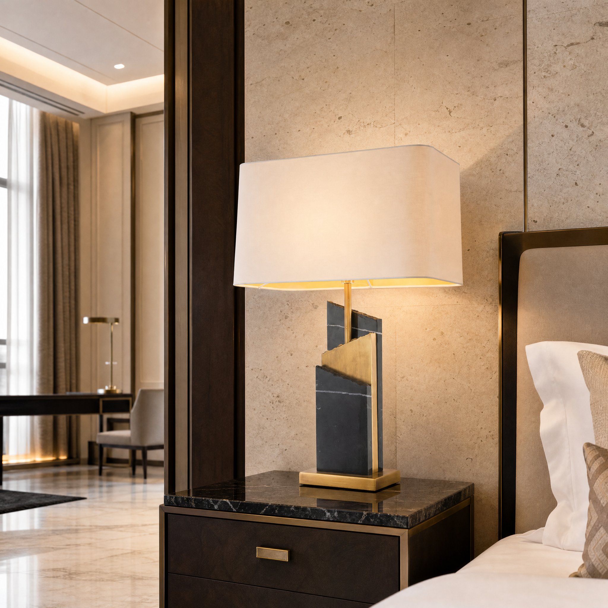 Sophisticated Zarello designer table lamp illuminating a high-end hospitality suite bedside table.
