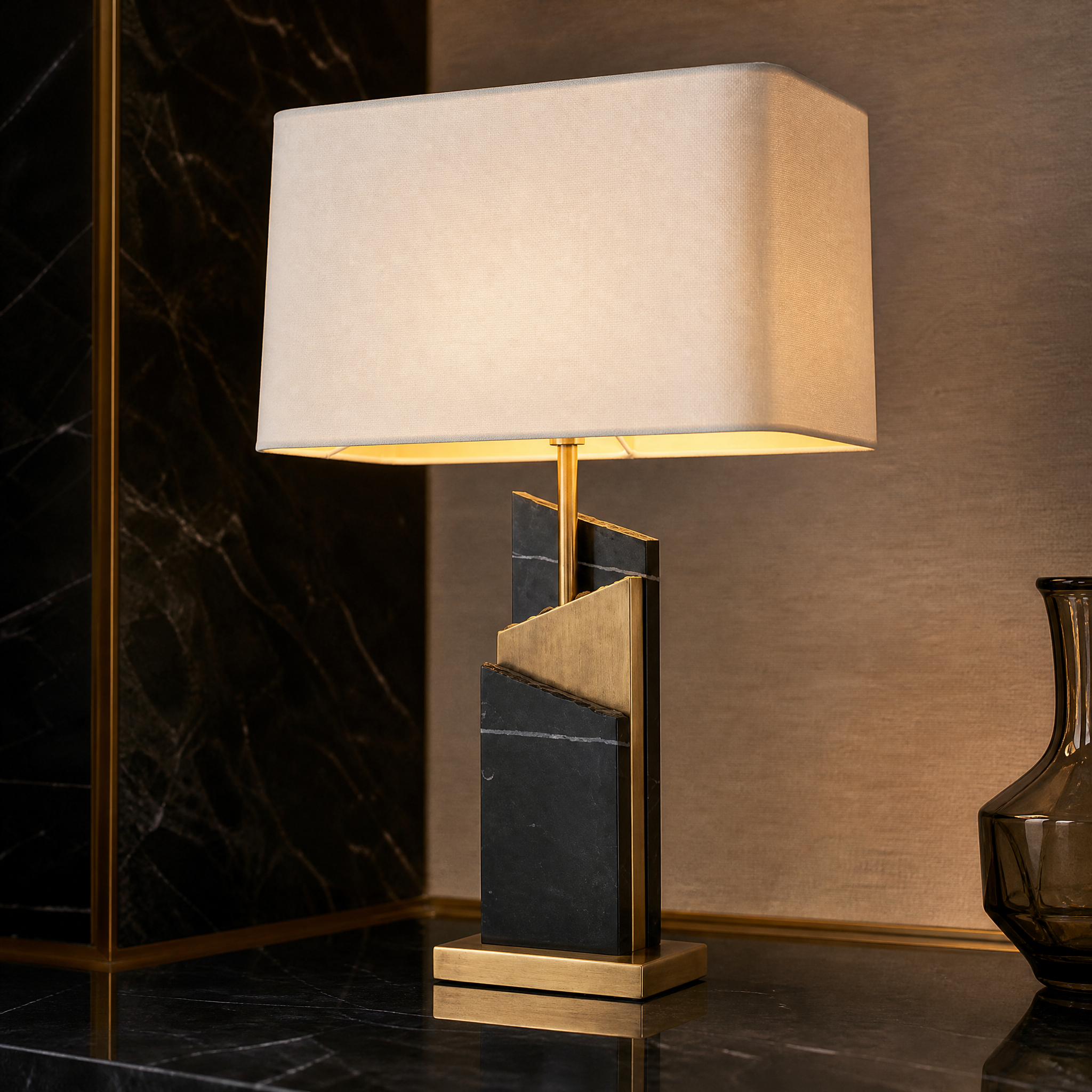 Macro shot of Zarello lamp base showcasing the texture contrast between brushed brass detailing and sculptural black marble.