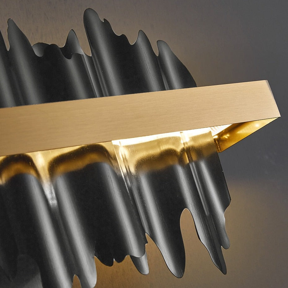 Close-up of Douala Wall Light showcasing sculptural fin details and gold frame