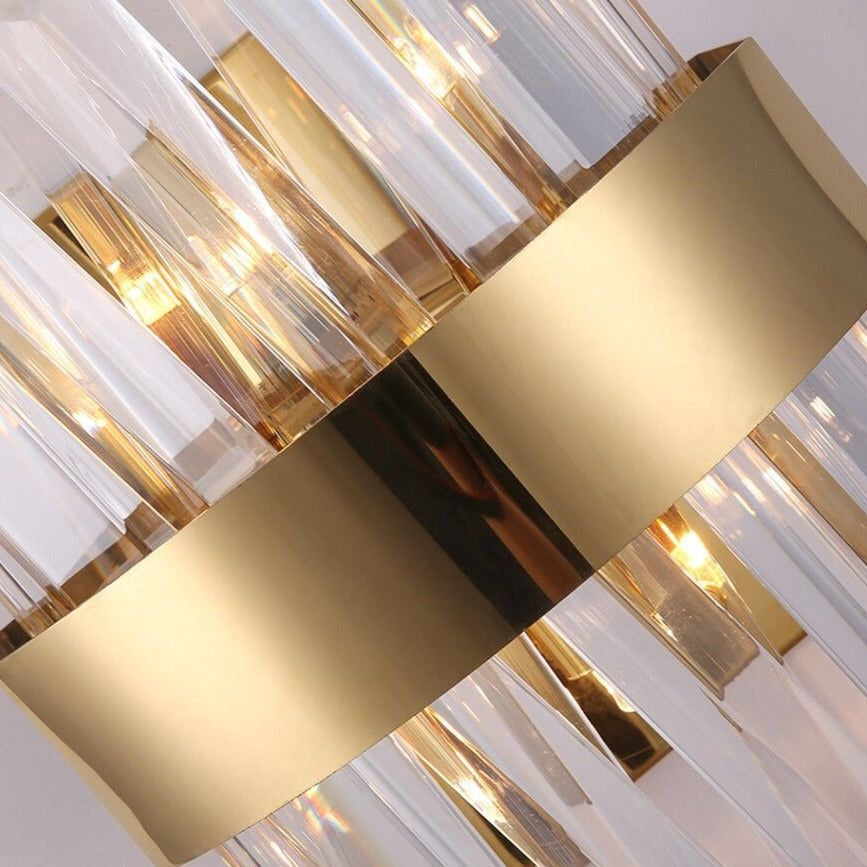 Illuminated crystal bar detail showing warm ambient light from a modern luxury wall sconce