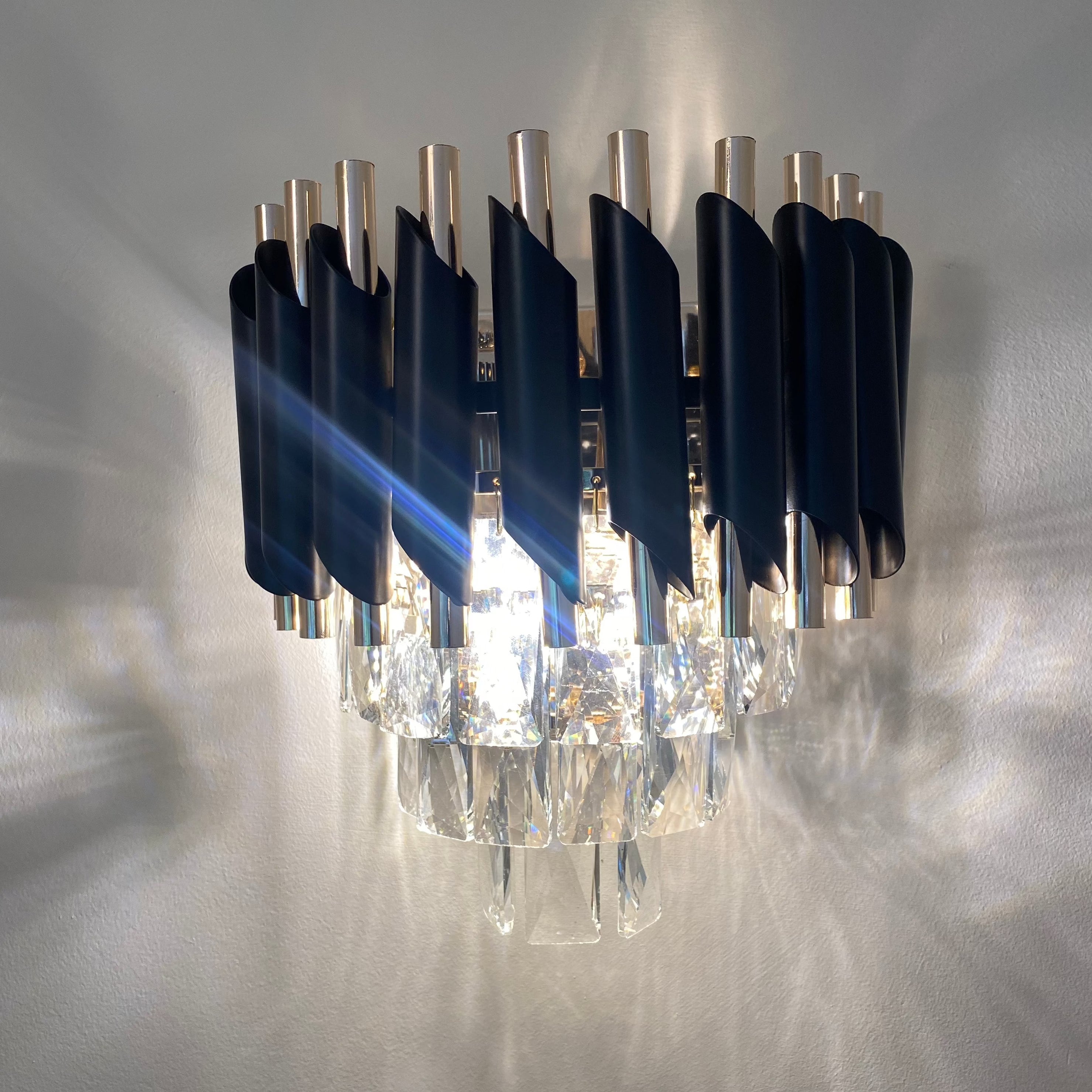 Milltimber wall light with deep blue rectangular crystals creating a dramatic ambient glow