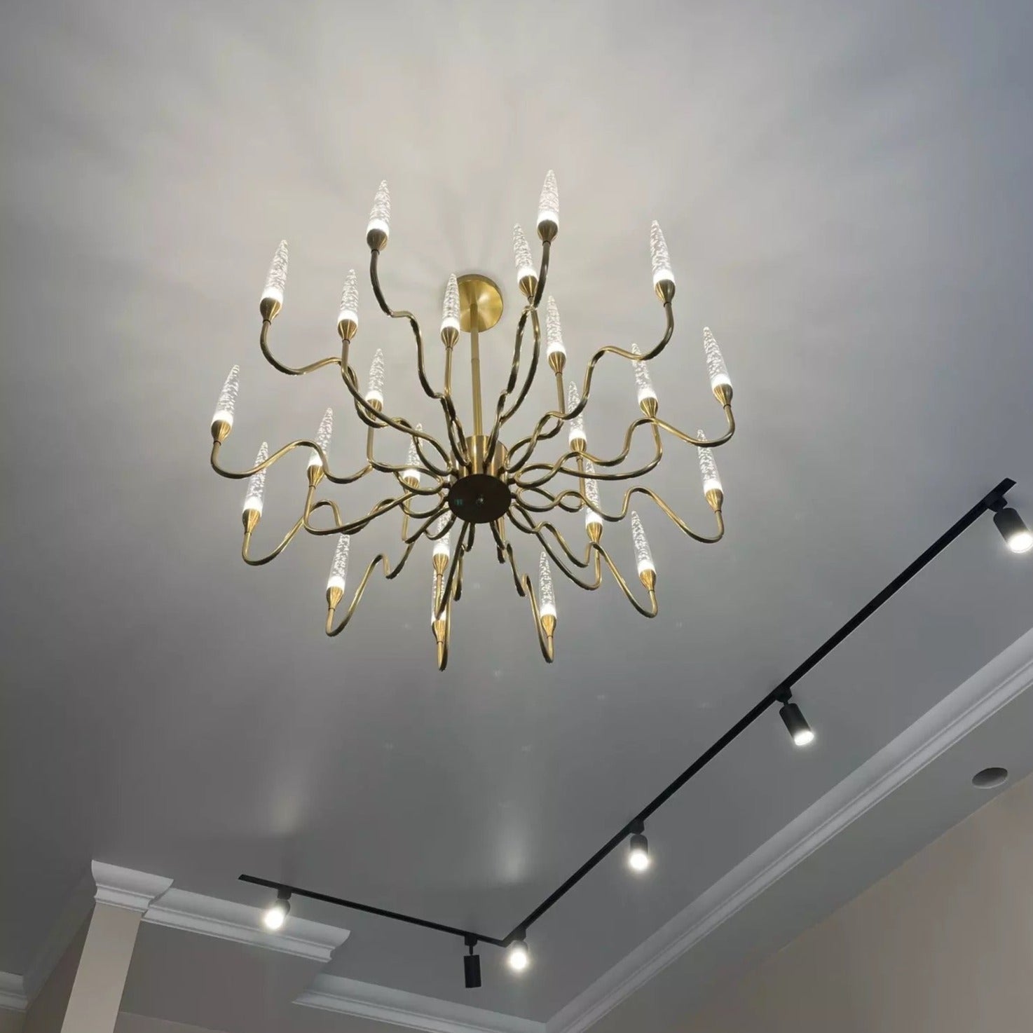 Modern chandelier with bubble crystal elements illuminating ceiling