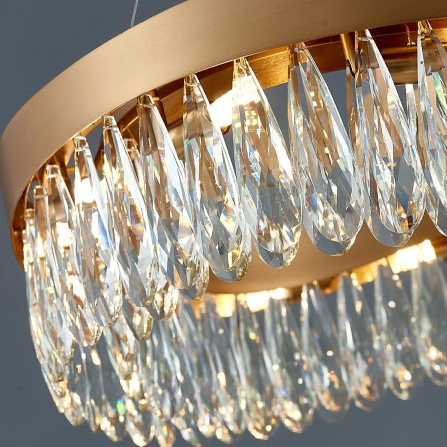 Detailed view of faceted teardrop crystal elements on a luxury circular chandelier frame