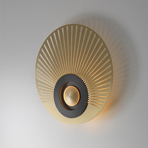 Detailed view of illuminated central light element within Piatto Series disc wall sconce creating soft ambient glow