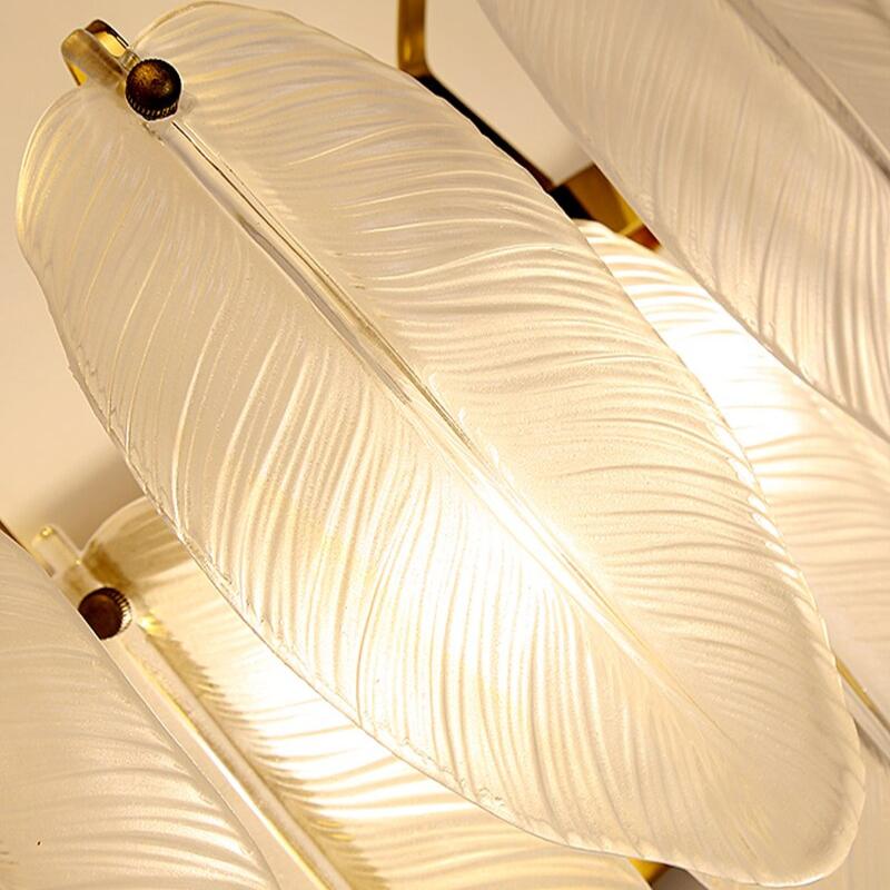 Detailed view of translucent feather crystal elements on Piuma decorative wall sconce