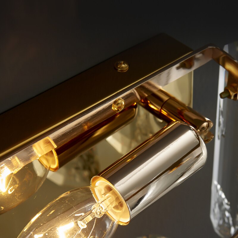 Detailed view of structured wall mount and oblong crystal assembly on Stellina wall sconce