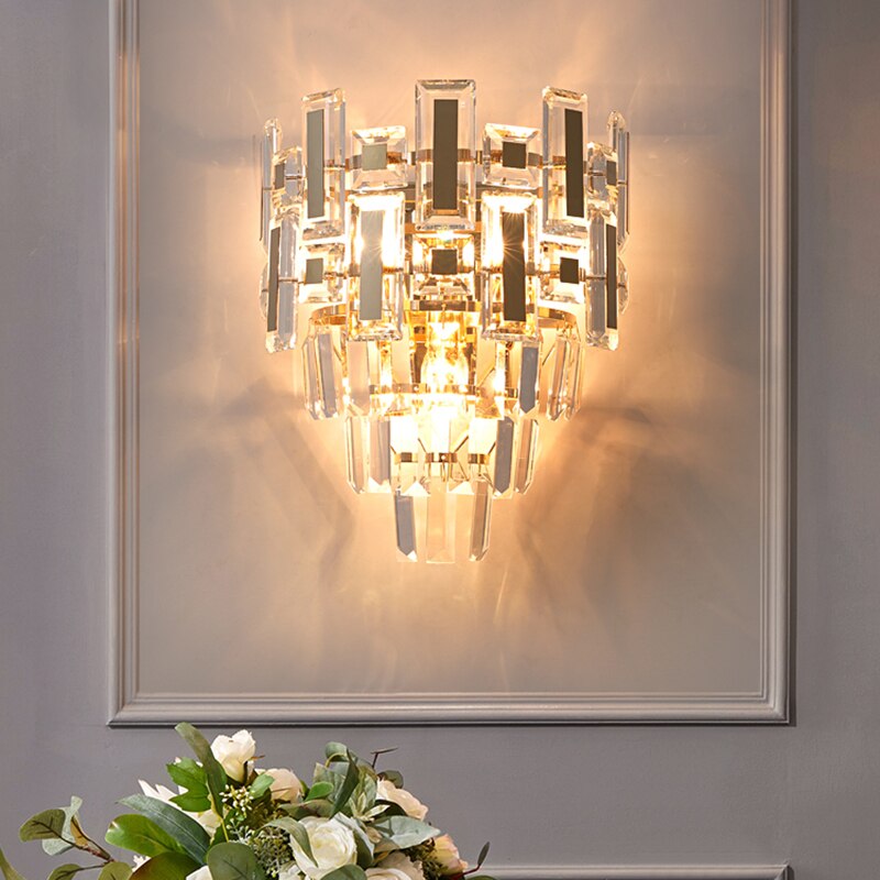 Crystal wall light installed on a panelled wall adding soft, ambient illumination.