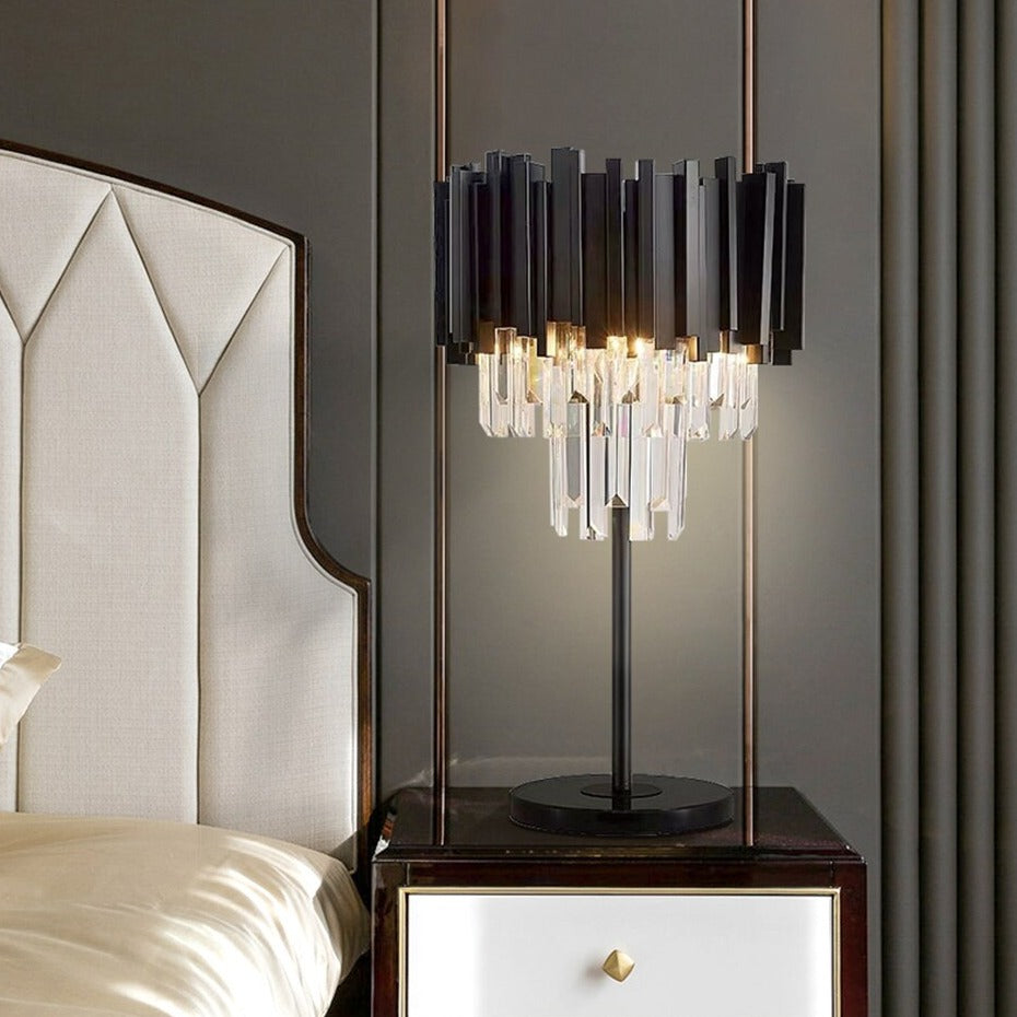 Boeotia Table Lamp placed beside a luxury bed, featuring black cuboid tubing and shimmering crystal bars.