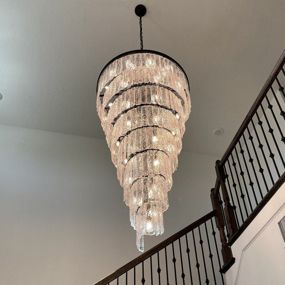 Upward architectural view of a spiral crystal staircase chandelier with cascading illumination