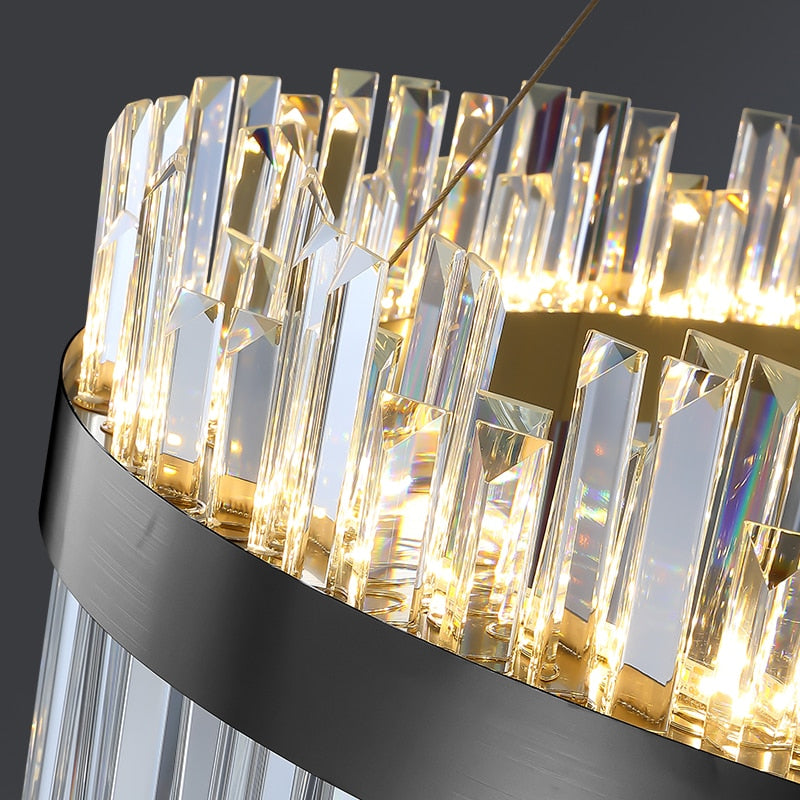 Glowing diamond-cut crystal bars surrounding the stainless steel frame of the VORELLI Medina rectangular chandelier