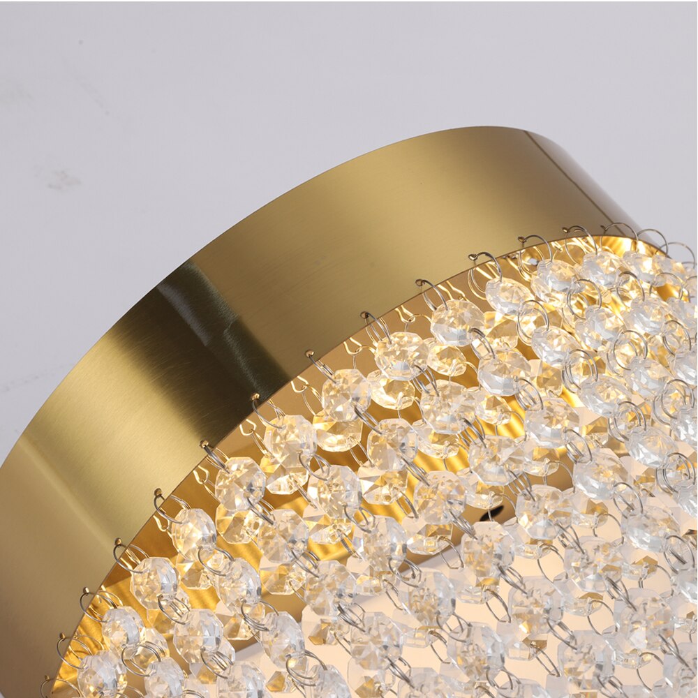 Close up of VORELLI® Modesto crystal wall light highlighting diamond cut octagon crystal chains and structured upper frame