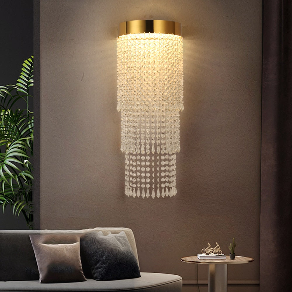 VORELLI® Modesto modern crystal wall sconce creating soft ambient lighting in refined bedroom interior
