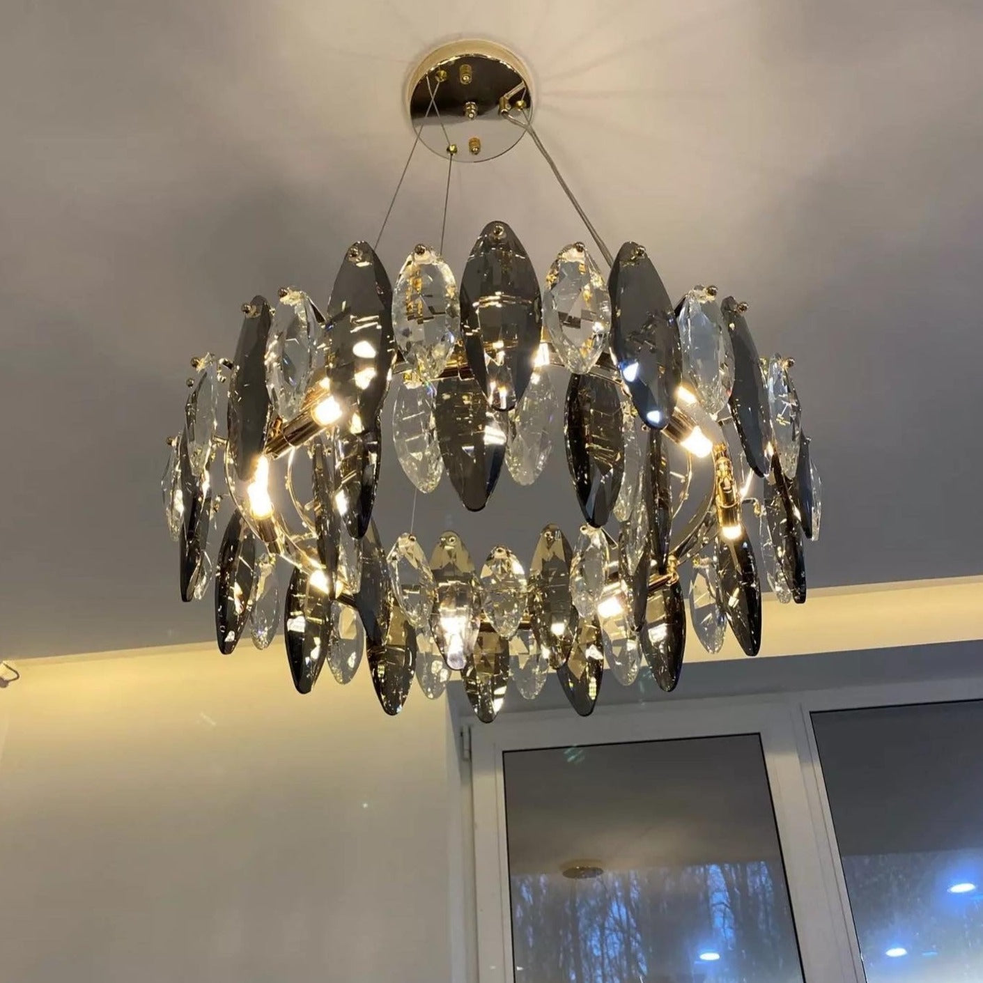 VORELLI® Oakhill modern circular crystal chandelier installed in refined living space with sculptural oval detailing