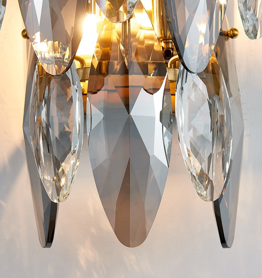 Close up side view of VORELLI® Oakhill crystal wall light highlighting layered clear and smoky oval crystal elements with sculptural frame