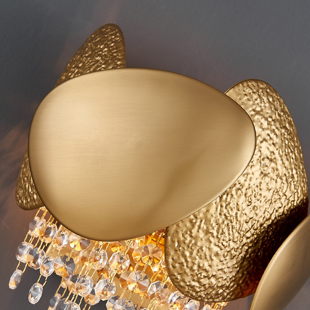 Detailed view of sculptural pebble inspired frame on VORELLI® Palatino wall sconce