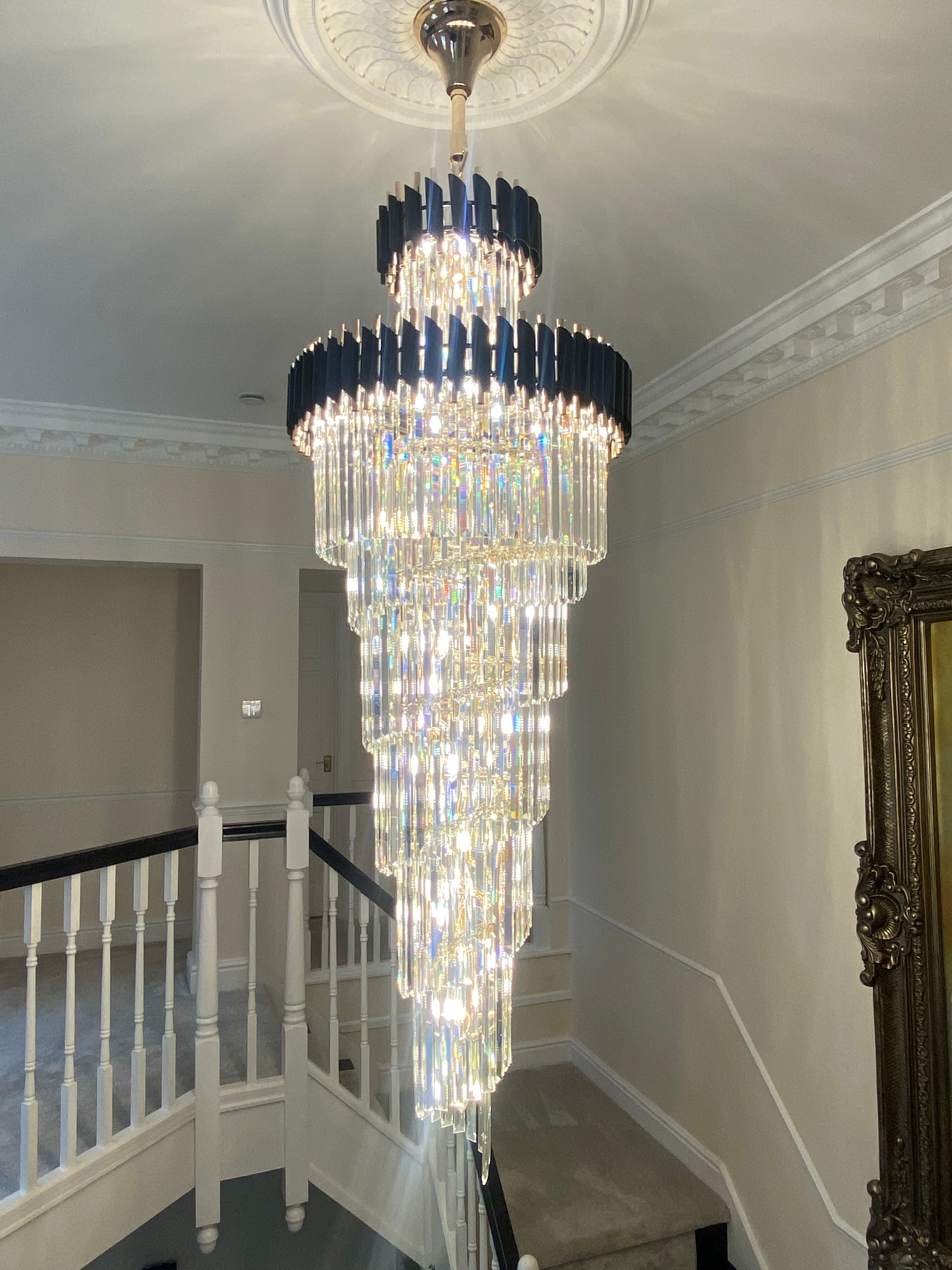 Close-up of cascading crystal drop on a luxury VORELLI® staircase chandelier
